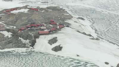 Wide shots of the Dumont D'Urville Base surrounded by  Adelie penguins