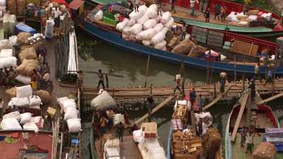 Loading small boats in Sadarghat harbour