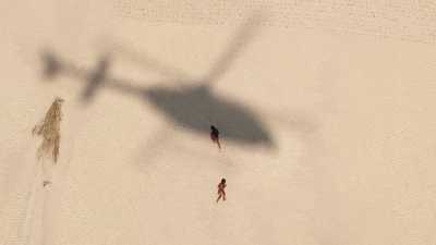 Children running after the helicopter shadow