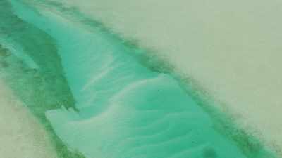 Turquoise waters meander between sandbanks