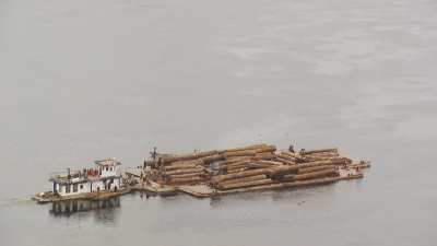 Wood transportation on half-sunken barge