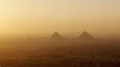 Giza archaeological site in the far at sundown