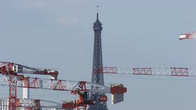 Eiffel Tower behind cranes