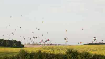 Air balloons flying over fields