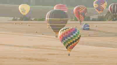 Air balloons flying over fields