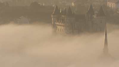Castle and city of Saumur in the morning fog
