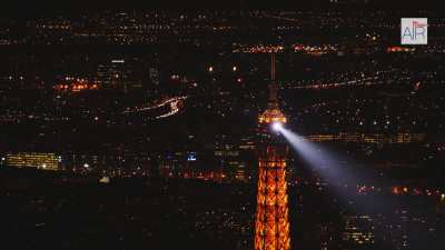 The Eiffel Tower at night with twinkling lights on