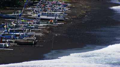 Rice charging on boats on the black sand beaches