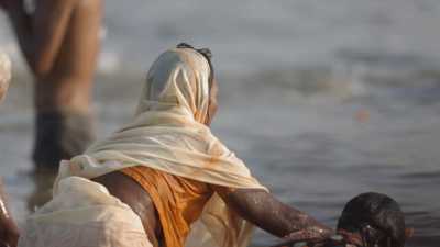 Women and Sadhu's bath during Kumbh Mela