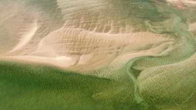 Water meanders in the sand