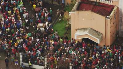 Wide shots of crowd around destroyed Tacloban's church