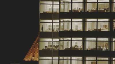 Very close shots of office buildings in Manhattan by night